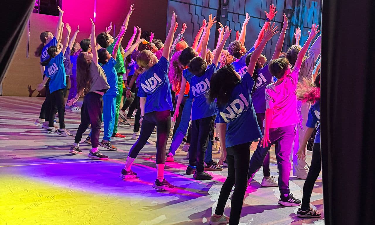 Kids jumping in the air with arms up