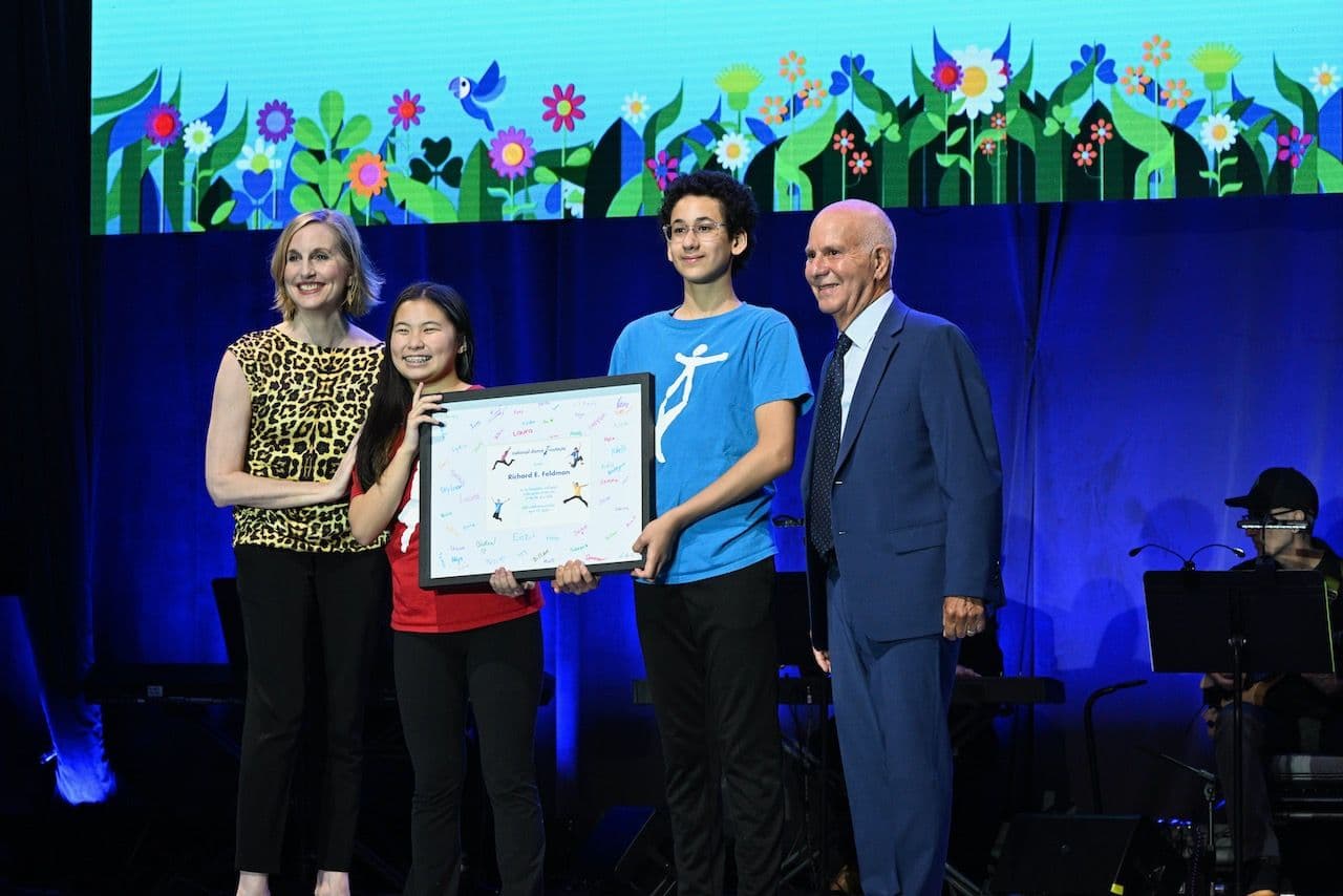 two kids receiving an award