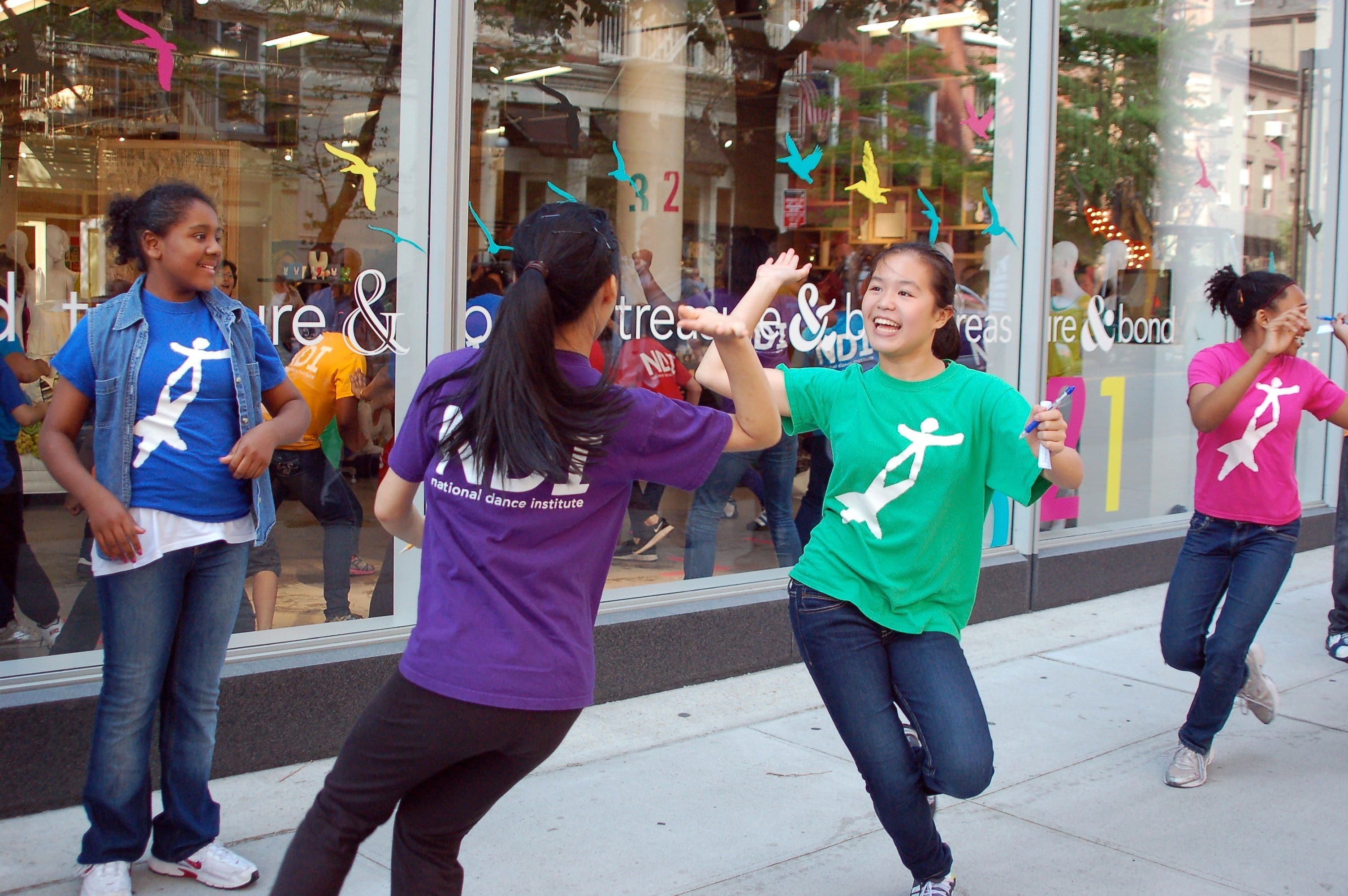 Kids dancing on a sidewalk