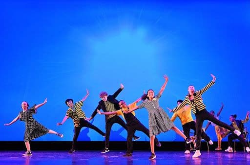 Group of people dancing on stage