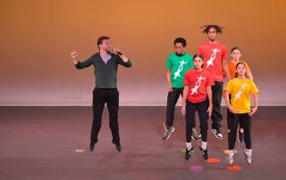 Energetic dance performance by diverse youth at National Dance Institute showcase.